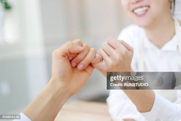 young love couple pinky promise at home - pinky promise stock pictures, royalty-free photos & images