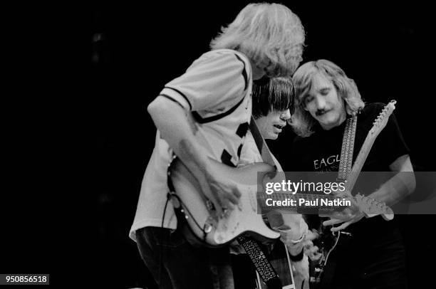 Don Felder and Joe Walsh of The Eagles with Jackson Browne at the Chicago Stadium on October 22, 1979 in Chicago, Illinois.