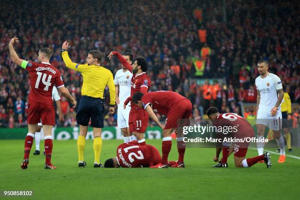 Team mates call for a stretcher after Alex Oxlade-Chamberlain of Liverpool injures his knee. During the UEFA Champions League Semi Final First Leg...