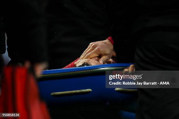 Alex Oxlade-Chamberlain of Liverpool reacts as he is taken off on a stretcher during the UEFA Champions League Semi Final First Leg match between...