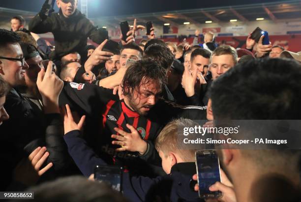 Blackburn Rovers' Charlie Mulgrew is mobbed by fans as Blackburn Rovers get promoted after the Sky Bet League One match at the Keepmoat Stadium,...