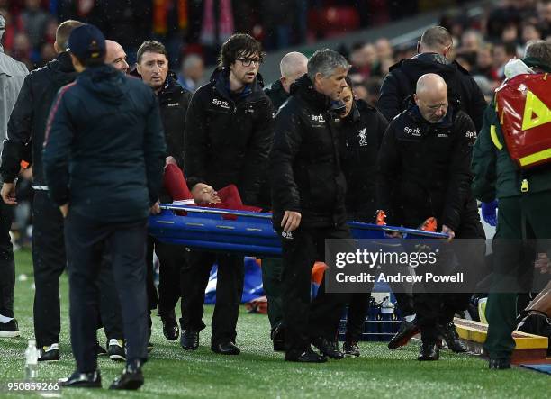 Alex Oxlade-Chamberlain of Liverpool brough off after being injured during the UEFA Champions League Semi Final First Leg match between Liverpool and...