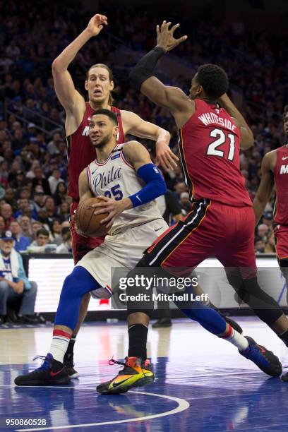 Ben Simmons of the Philadelphia 76ers drives to the basket against Kelly Olynyk and Hassan Whiteside of the Miami Heat during Game Two of the first...