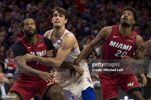 James Johnson and Justise Winslow of the Miami Heat box out Dario Saric of the Philadelphia 76ers during Game Two of the first round of the 2018 NBA...