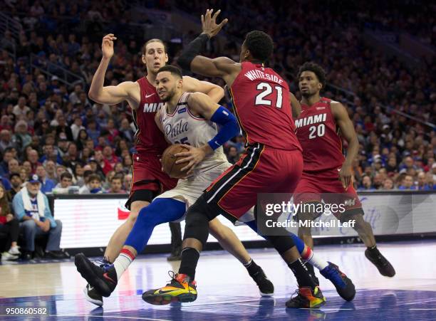 Ben Simmons of the Philadelphia 76ers drives to the basket against Kelly Olynyk, Hassan Whiteside and Justise Winslow of the Miami Heat during Game...