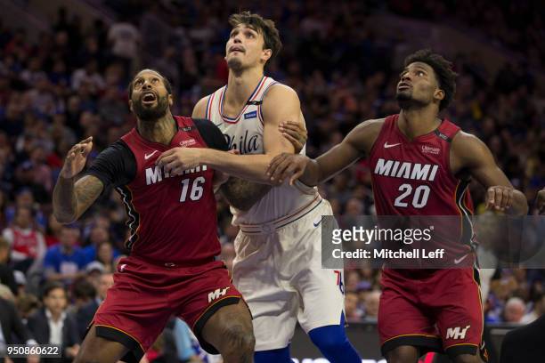 James Johnson and Justise Winslow of the Miami Heat box out Dario Saric of the Philadelphia 76ers during Game Two of the first round of the 2018 NBA...