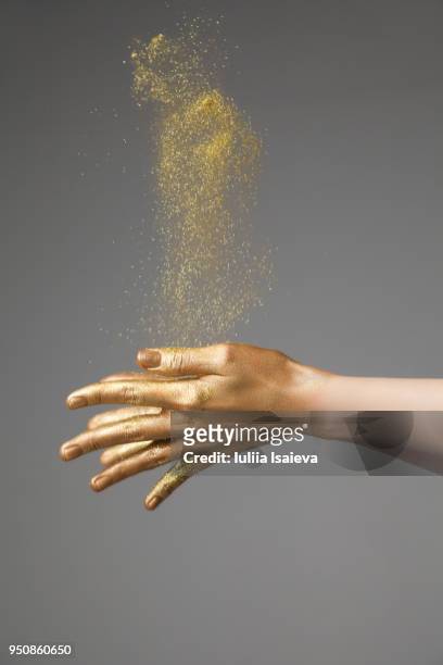 crop hands throwing gold dust - art modeling studio stock pictures, royalty-free photos & images