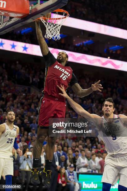 James Johnson of the Miami Heat dunks the ball against Dario Saric of the Philadelphia 76ers during Game Two of the first round of the 2018 NBA...