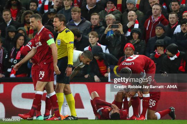 Alex Oxlade-Chamberlain of Liverpool reacts after picking up an injury which results in him being take off on a stretcher during the UEFA Champions...