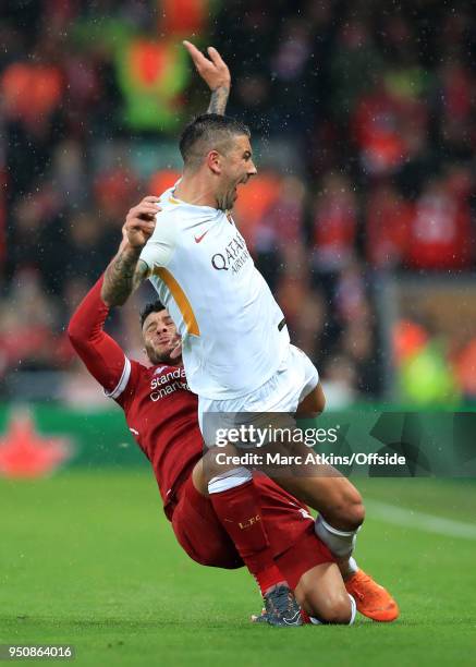 Alex Oxlade-Chamberlain of Liverpool appears to injure his right knee in this challenge on Aleksandar Kolarov of A.S.Roma during the UEFA Champions...