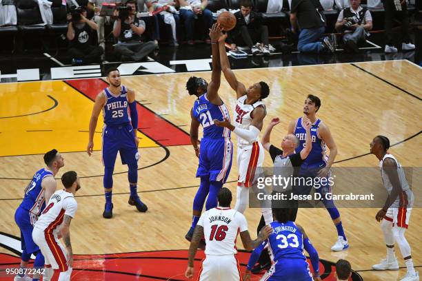 Joel Embiid of the Philadelphia 76ers and Hassan Whiteside of the Miami Heat reach for tip off to start Game Four of Round One of the 2018 NBA...