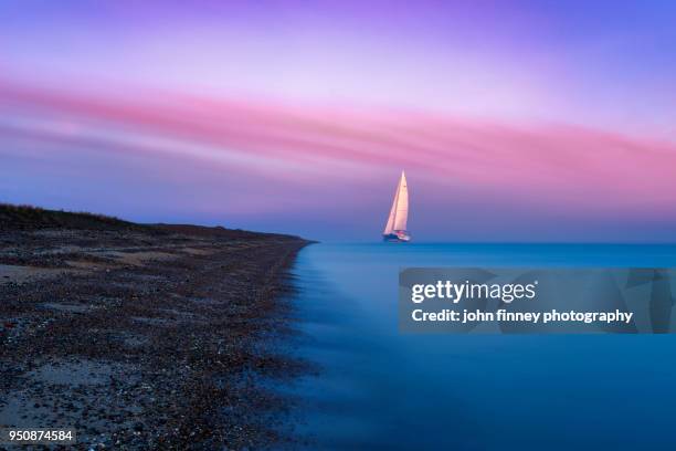 a large sailing boat of the isle of sheppey at sunrise, kent. uk - smooth sailing stock pictures, royalty-free photos & images