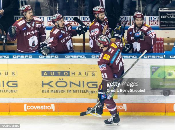 Louis-Marc Aubry of Eisbaeren Berlin celebrates with team mates after scoring his team's first goal during the DEL Playoff final match 6 between...