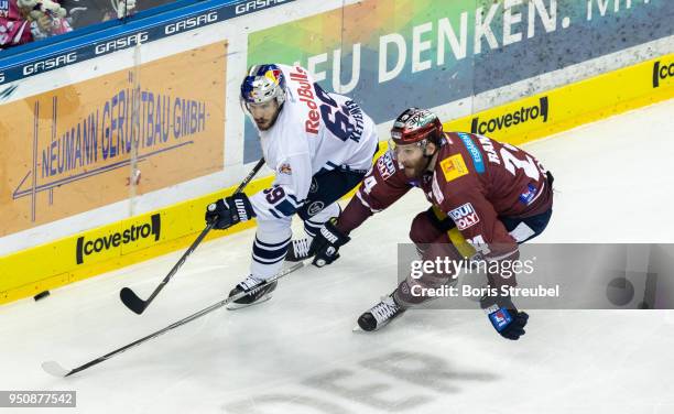 Andre Rankel of Eisbaeren Berlin in action with Florian Kettemer of Red Bull Muenchen during the DEL Playoff final match 6 between Eisbaeren Berlin...