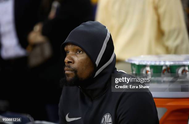 Kevin Durant of the Golden State Warriors sits on the bench before their game against the San Antonio Spurs during Game 2 of Round 1 of the 2018 NBA...