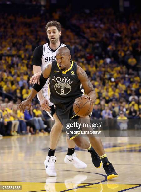 David West of the Golden State Warriors dribes past Pau Gasol of the San Antonio Spurs during Game 2 of Round 1 of the 2018 NBA Playoffs at ORACLE...