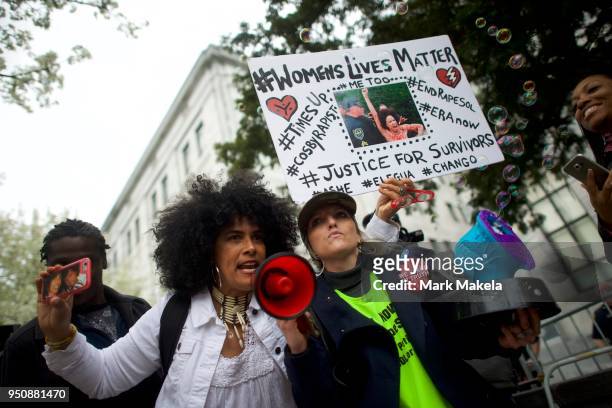 Bill Cosby accuser Lili Bernard and activist Bird Milliken protest outside the Montgomery County Courthouse, as Cosby departs after the twelfth day...