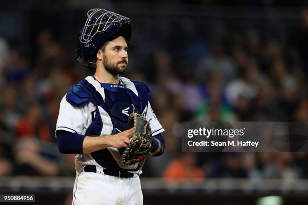 Austin Hedges of the San Diego Padres looks on during a game against the San Francisco Giants at PETCO Park on April 12, 2018 in San Diego,...