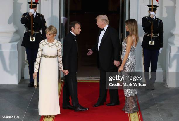 President Donald Trump and U.S. First lady Melania Trump greet French President Emmanuel Macron and French first lady Brigitte Macron after their...