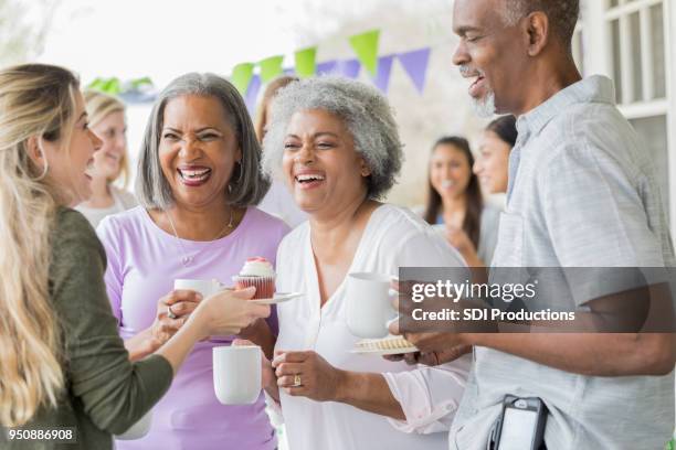 friends enjoy coffee and cake at fundraising event - issue celebration stock pictures, royalty-free photos & images