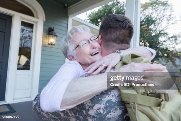 senior mom hugs military son - homecoming stock pictures, royalty-free photos & images