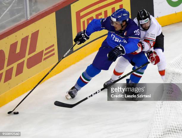 Andrew Sarauer of Hungary challenges Ivan Deluca of Italy during the 2018 IIHF Ice Hockey World Championship Division I Group A match between Italy...