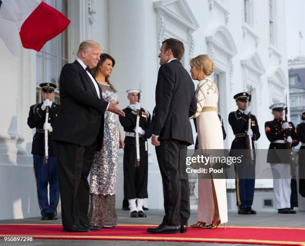 President Donald Trump and U.S. First lady Melania Trump greet French President Emmanuel Macron and French first lady Brigitte Macron after their...