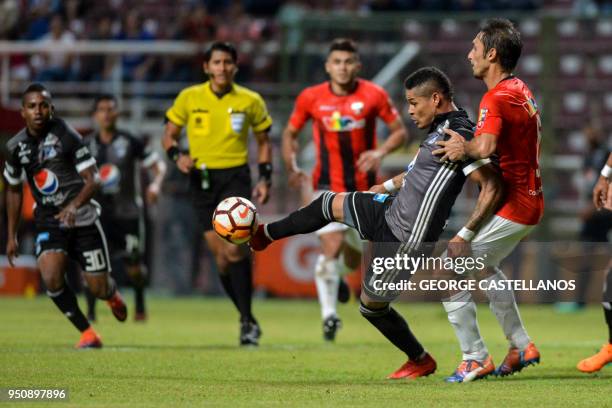 Colombia's Millonarios forward Ayron del Valle vies for the ball with Venezuela's Deportivo Lara midfielder David Mendoza, during their Copa...