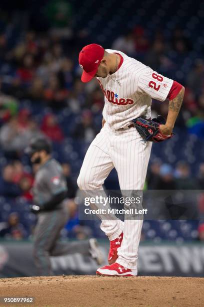 Vince Velasquez of the Philadelphia Phillies looks down after allowing a solo home run to Alex Avila of the Arizona Diamondbacks in the top of the...