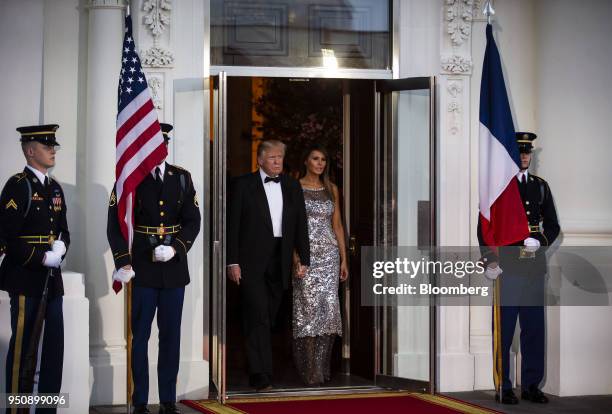 President Donald Trump, center left, and U.S. First Lady Melania Trump, center right, arrive to greet Emmanuel Macron, France's president, and...