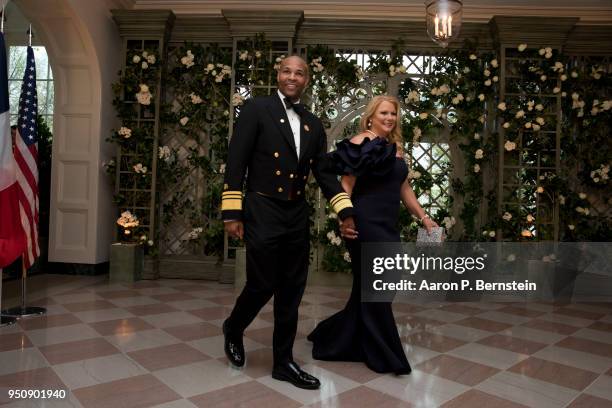 Surgeon General Jerome Adams and his wife Stacey arrive at the White House for a state dinner April 24, 2018 in Washington, DC . President Donald...