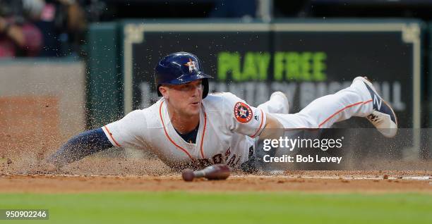 Alex Bregman of the Houston Astros scores in the second inning against the Los Angeles Angels of Anaheim at Minute Maid Park on April 24, 2018 in...