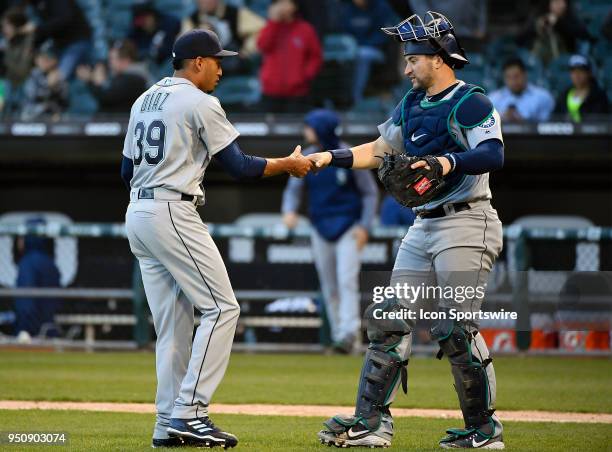 Seattle Mariners relief pitcher Edwin Diaz and Seattle Mariners catcher Mike Zunino shake hands after getting the win against the Chicago White Sox...