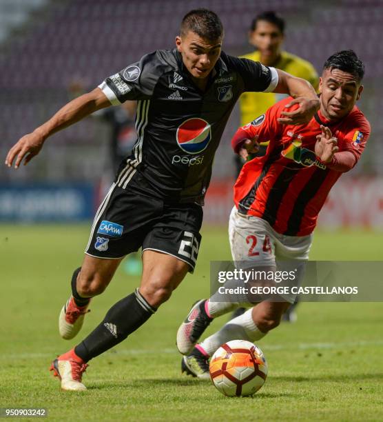 Colombia's Millonarios midfielder Jhon Duque vies for the ball with Venezuela's Deportivo Lara midfielder Heribert Soto, during their Copa...