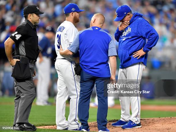 Kansas City Royals manager Ned Yost looks on as head trainer Nick Kenney checks on starting pitcher Ian Kennedy in the third inning against the...