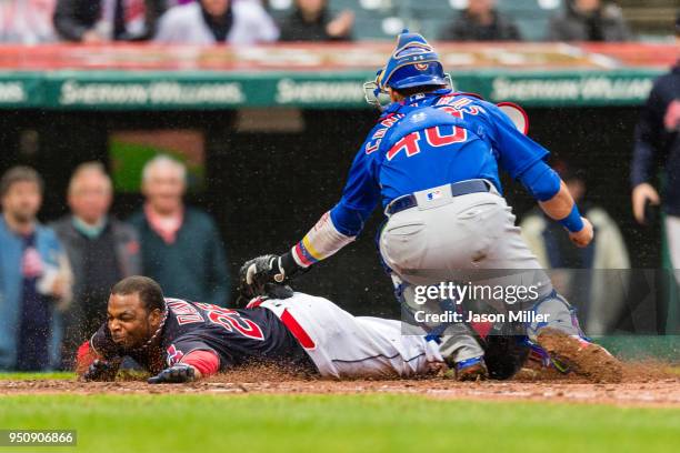 Rajai Davis of the Cleveland Indians is tagged out at home by catcher Willson Contreras of the Chicago Cubs to end the third inning at Progressive...