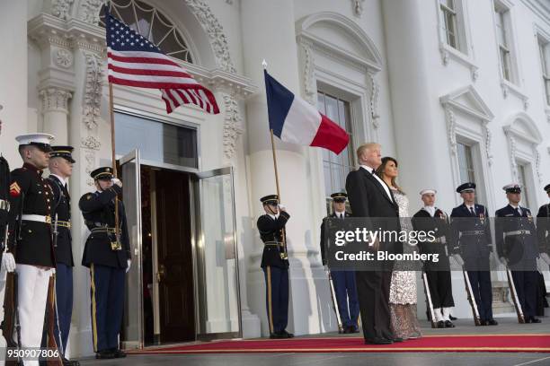 President Donald Trump, center left, and U.S. First Lady Melania Trump, center right, arrive to greet Emmanuel Macron, France's president, and...