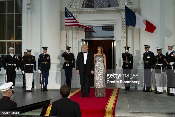 President Donald Trump, center left, and U.S. First Lady Melania Trump, center right, arrive to greet Emmanuel Macron, France's president, bottom,...