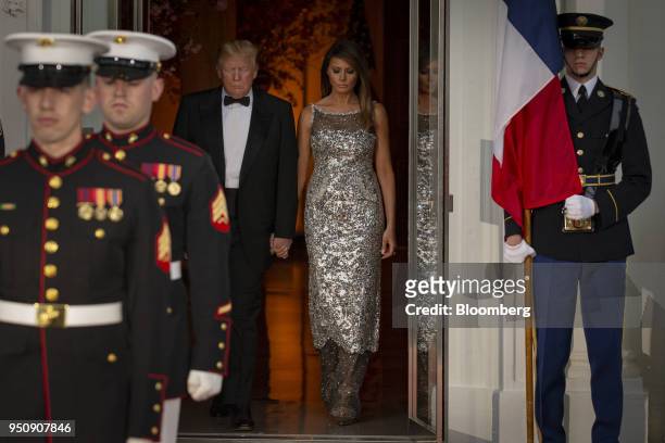 President Donald Trump, center left, and U.S. First Lady Melania Trump, center right, arrive to greet Emmanuel Macron, France's president, and...