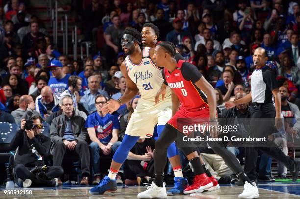 Joel Embiid of the Philadelphia 76ers battles for position against Hassan Whiteside and Josh Richardson of the Miami Heat in Game Five of Round One...