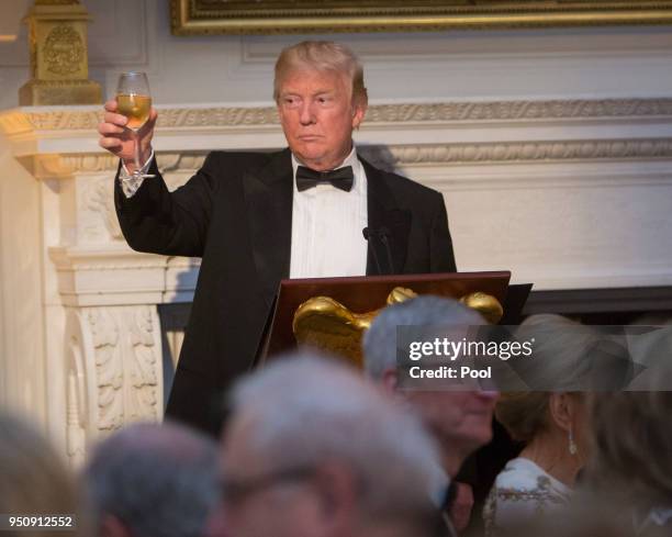 President Donald Trump makes a toast during the State Dinner on April 24, 2018 in Washington, DC. President Trump is hosting French President...