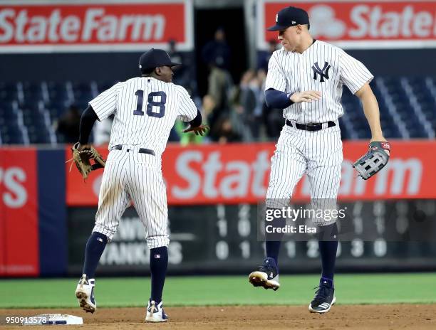Didi Gregorius and Aaron Judge of the New York Yankees celebrate the 8-3 win over the Minnesota Twins at Yankee Stadium on April 24, 2018 in the...