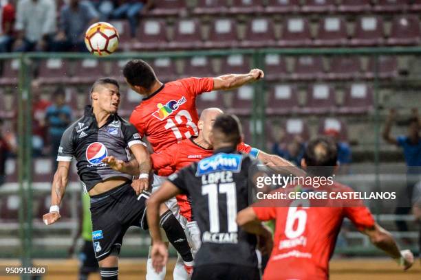 Colombia's Millonarios forward Ayron del Valle vies for the ball with Venezuela's Deportivo Lara defender Henri Pernia, during their Copa...