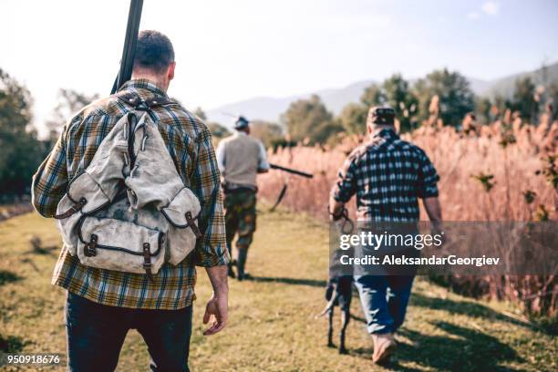 group of hunters with their dogs going for hunting action - hobby bird of prey stock pictures, royalty-free photos & images