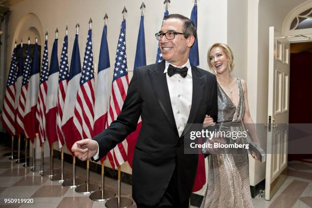 Steven Mnuchin, U.S. Treasury secretary, left, and Louise Linton arrive for a state dinner in honor of French President Emanuel Macron at the White...