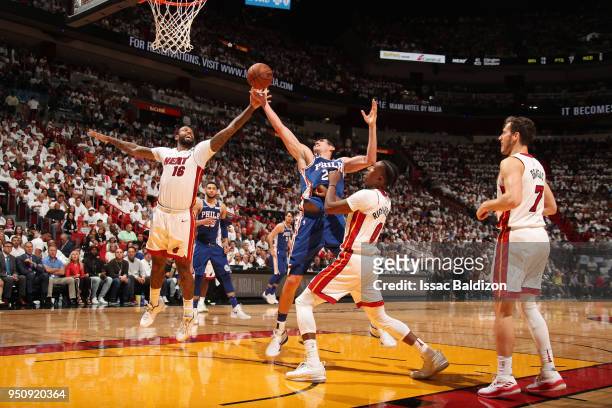 Ersan Ilyasova of the Miami Heat and James Johnson of the Miami Heat compete for the ball in Game Four of the Eastern Conference Quarterfinals during...