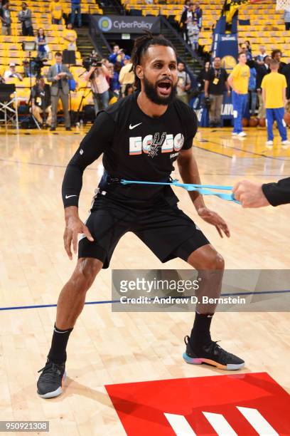 Patty Mills of the San Antonio Spurs warms up before the game against the Golden State Warriors in Game Five of Round One of the 2018 NBA Playoffs on...
