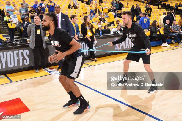 Patty Mills of the San Antonio Spurs warms up before the game against the Golden State Warriors in Game Five of Round One of the 2018 NBA Playoffs on...
