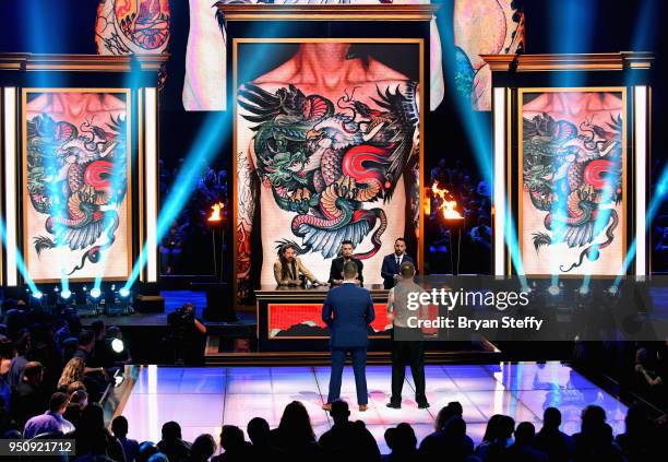 Juan Salgado and judges Oliver Peck, Dave Navarro and Chris Nunez speak onstage during the competition phase of the Ink Master Season 10 Finale at...