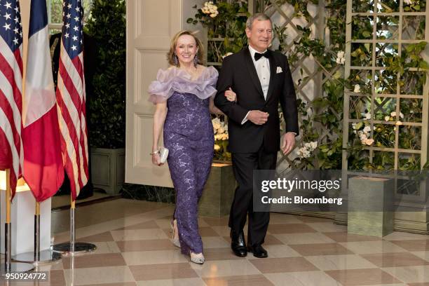 Supreme Court Chief Justice John Roberts, right, and Jane Roberts, arrive for a state dinner in honor of French President Emmanuel Macron at the...